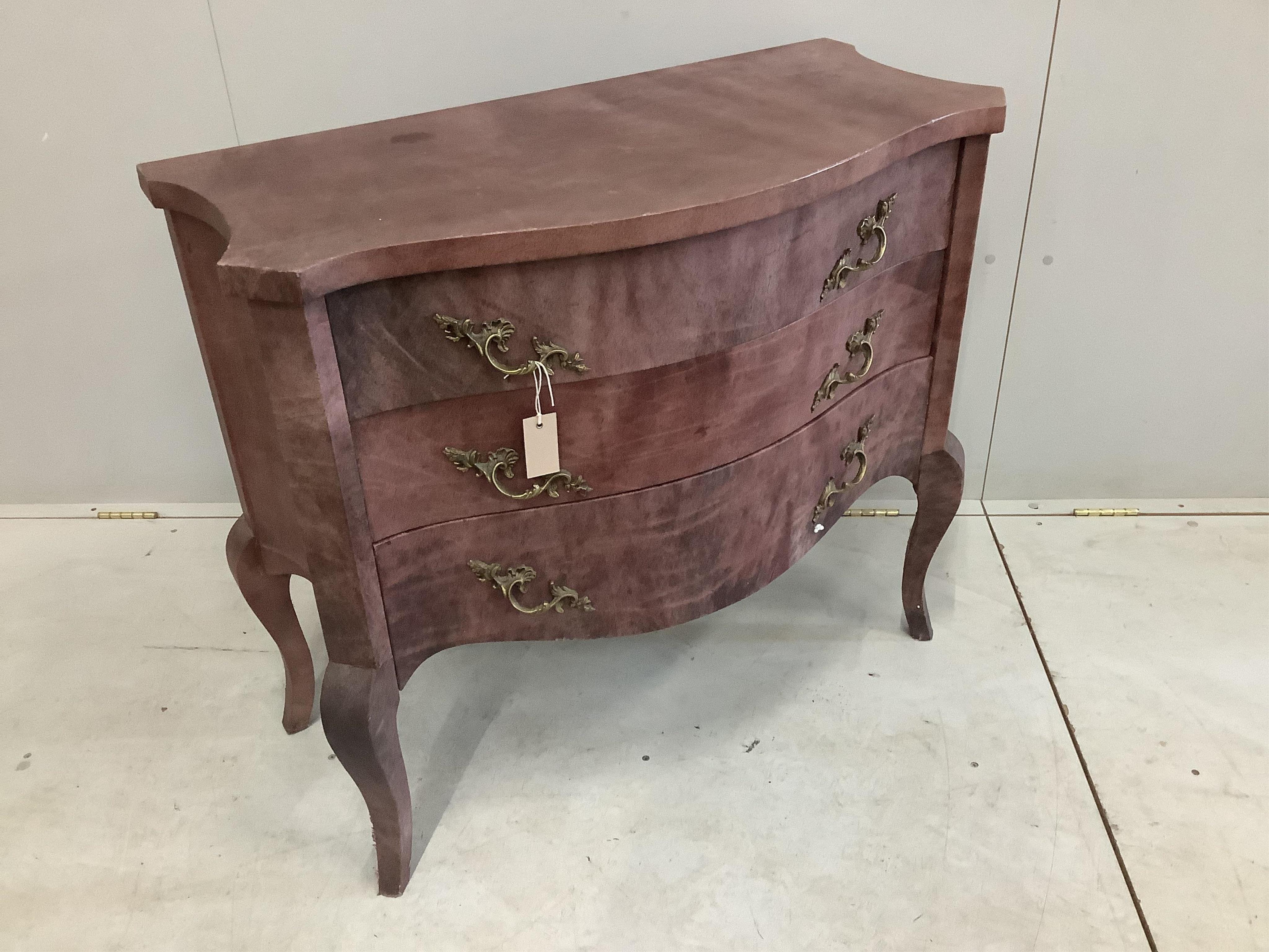 A Continental serpentine three drawer commode with simulated marble covering, width 91cm, height 81cm. Condition - fair condition